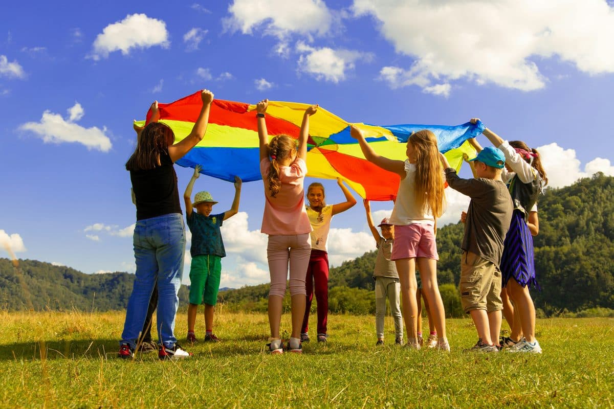 Kids playing with a parachute outdoors